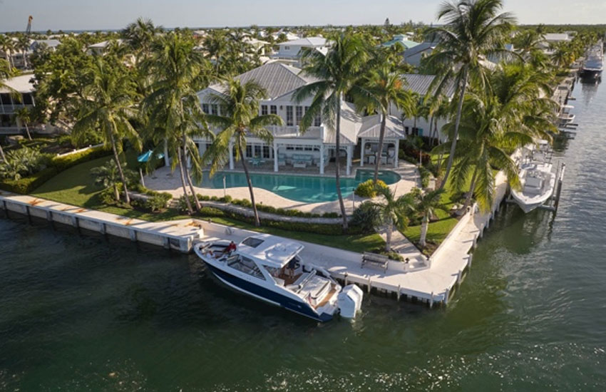 house with boat parked infront of it